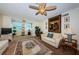 Cozy living room with ceiling fan, large area rug, and comfortable furnishings at 841 4Th N Ave # 21, St Petersburg, FL 33701