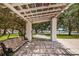 Peaceful park view with a pergola, bench, and trees leading to a waterfront area for relaxation at 841 4Th N Ave # 21, St Petersburg, FL 33701