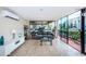 Bright sunroom with tile floors, large windows offering views, and a comfortable sofa and seating area at 841 4Th N Ave # 21, St Petersburg, FL 33701