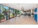 Bright sunroom featuring tile floors, expansive windows, and a welcoming entrance to the property at 841 4Th N Ave # 21, St Petersburg, FL 33701