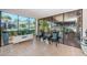 Bright sunroom with tile flooring, large windows offering views, and stylish seating for relaxation at 841 4Th N Ave # 21, St Petersburg, FL 33701