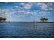 Calm water view, a white boat on the horizon, framed by palm trees on either side at 841 4Th N Ave # 21, St Petersburg, FL 33701