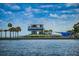 Modern waterfront building with restaurant and outdoor seating, nestled among lush palm trees along the coast at 841 4Th N Ave # 21, St Petersburg, FL 33701