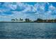 Stunning waterfront view with calm waters, distant buildings, palm trees, and a clear blue sky with clouds at 841 4Th N Ave # 21, St Petersburg, FL 33701