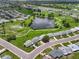 Community aerial shot showcases the pond, green spaces, and orderly neighborhood layout at 913 Augusta Dr, Sun City Center, FL 33573