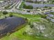 Scenic aerial shot of a community with a lake, walking paths, and lush green spaces at 913 Augusta Dr, Sun City Center, FL 33573