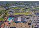 Aerial view of community clubhouse featuring a pool, lawn bowling, and ample parking in a beautifully maintained area at 913 Augusta Dr, Sun City Center, FL 33573
