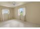 Cozy bedroom with two windows providing ample natural light at 913 Augusta Dr, Sun City Center, FL 33573