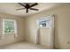 Bright bedroom featuring two windows and a ceiling fan at 913 Augusta Dr, Sun City Center, FL 33573