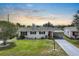 Lovely home with manicured lawn and flowerbeds, complemented by an attached carport at 913 Augusta Dr, Sun City Center, FL 33573