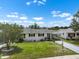 Charming single-story home with a well-maintained lawn and landscaping under a bright blue sky at 913 Augusta Dr, Sun City Center, FL 33573