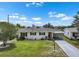 Charming single story home featuring a well-manicured lawn and a covered carport at 913 Augusta Dr, Sun City Center, FL 33573