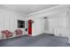 Covered front porch area with seating, leading to a red front door and additional entry at 913 Augusta Dr, Sun City Center, FL 33573