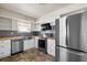 Bright kitchen with stainless steel appliances, white cabinets, and unique backsplash at 913 Augusta Dr, Sun City Center, FL 33573