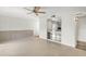 Spacious living room featuring tiled floors and a pass-through to the kitchen with storage at 913 Augusta Dr, Sun City Center, FL 33573