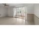 Living room with tiled floors and sliding glass doors to a sunroom at 913 Augusta Dr, Sun City Center, FL 33573