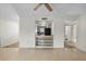 Open living room with tiled floors and a pass-through to the kitchen with open shelves at 913 Augusta Dr, Sun City Center, FL 33573