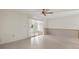 Living room with tiled floors and sliding glass doors to an enclosed sunroom at 913 Augusta Dr, Sun City Center, FL 33573
