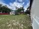 Expansive backyard featuring a shed, trailer, partial fence, and space for outdoor activities at 9218 N 52Nd St, Tampa, FL 33617