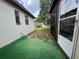 Backyard with a screened-in patio, green turf, and a view of the house's exterior at 9218 N 52Nd St, Tampa, FL 33617