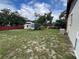 Expansive backyard featuring a shed, trailer, partial fence, and space for outdoor activities at 9218 N 52Nd St, Tampa, FL 33617