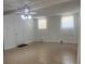 Spacious bedroom with neutral walls, tile floor, ceiling fan and two windows with blinds at 9218 N 52Nd St, Tampa, FL 33617