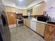 Cozy kitchen featuring stainless steel appliances, wood cabinets, and neutral countertops at 9218 N 52Nd St, Tampa, FL 33617