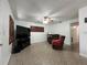 Bright living room with a ceiling fan, TV, and comfy recliner chairs at 9218 N 52Nd St, Tampa, FL 33617