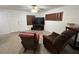 Cozy living room featuring a ceiling fan, television, and comfortable armchairs at 9218 N 52Nd St, Tampa, FL 33617