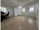 Spacious living room featuring neutral tile floors, bright lighting, and a comfortable atmosphere at 9218 N 52Nd St, Tampa, FL 33617