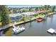 Stunning aerial view of a waterfront home with private dock, boat lift and lush landscaping at 9917 San Sierra Way, Port Richey, FL 34668