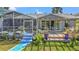 Inviting backyard with screened-in pool, wooden deck and pergola overlooking waterfront views at 9917 San Sierra Way, Port Richey, FL 34668