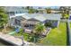 Charming backyard featuring a screened lanai, wooden deck with pergola, and access to the waterfront at 9917 San Sierra Way, Port Richey, FL 34668