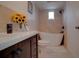 Elegant bathroom featuring a modern soaking tub, tiled walls, and stylish vanity at 9917 San Sierra Way, Port Richey, FL 34668