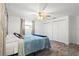 Bedroom featuring a ceiling fan, double closets and tile flooring at 9917 San Sierra Way, Port Richey, FL 34668