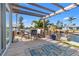 Outdoor deck with table and chairs, overlooking a canal, perfect for enjoying waterfront living at 9917 San Sierra Way, Port Richey, FL 34668