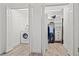 Bright laundry room with modern washer and dryer and access to a convenient walk-in closet at 9917 San Sierra Way, Port Richey, FL 34668