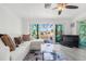 Cozy living room with canal view, features tile floors and lots of natural light at 9917 San Sierra Way, Port Richey, FL 34668