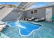 Private screened-in pool area with lounge chairs, providing a tranquil outdoor retreat at 9917 San Sierra Way, Port Richey, FL 34668