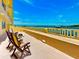 Spacious balcony with seating showcases the water view and creates an ideal retreat at 100 Bluff View Dr # 114C, Belleair Bluffs, FL 33770