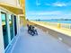 Long balcony with chairs offers stunning water view and an inviting outdoor space at 100 Bluff View Dr # 114C, Belleair Bluffs, FL 33770