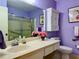 Well-lit bathroom with a large mirror, framed artwork, and a neutral color palette at 100 Bluff View Dr # 114C, Belleair Bluffs, FL 33770