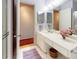 Well-lit bathroom features a shower, white countertops, framed artwork, and storage space at 100 Bluff View Dr # 114C, Belleair Bluffs, FL 33770