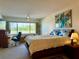 Cozy bedroom featuring a comfortable bed, a desk area by the window, and ample space to relax and unwind at 100 Bluff View Dr # 114C, Belleair Bluffs, FL 33770