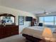 Comfortable bedroom with a large window offering bright natural light, plus a desk area for work at 100 Bluff View Dr # 114C, Belleair Bluffs, FL 33770