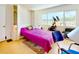 Efficient living space with a fold-out murphy bed, an exercise machine, and bright natural light from the window at 100 Bluff View Dr # 114C, Belleair Bluffs, FL 33770