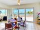 Charming dining area with waterfront views and access to an outdoor balcony, creating a perfect space for entertaining at 100 Bluff View Dr # 114C, Belleair Bluffs, FL 33770