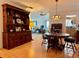 Inviting dining room with hardwood floors, a classic china cabinet, and views into the living room at 100 Bluff View Dr # 114C, Belleair Bluffs, FL 33770