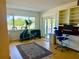 Bright exercise room with large windows, desk, built-ins, and access to a balcony at 100 Bluff View Dr # 114C, Belleair Bluffs, FL 33770