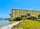 Coastal building exterior with well-maintained landscaping and waterfront access, perfect for seaside living at 100 Bluff View Dr # 114C, Belleair Bluffs, FL 33770